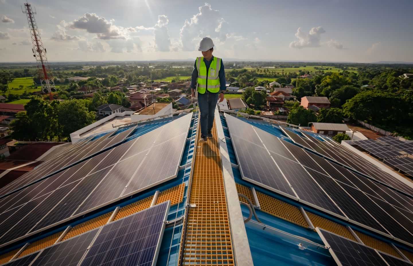 Solar roofing engineering technician working on top of high building. Solar Company Businessman is doing surveillance work on solar loop.
